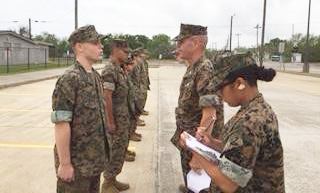  Cadet Sgt. Patrick Cooper (left) from Robert E. Lee High School is inspected by Col. Patrick Ferral (right), senior marine instructor from Ross S. Sterling High School, who volunteered for the REL MCJROTC
Annual Commanding Generals Inspection (I.G) held March 24. All cadets were evaluated on their appearance and military knowledge. Also pictured taking notes for Col. Ferral is Cadet 2nd Lt. Elissa Torres (right), a sophomore at REL. 