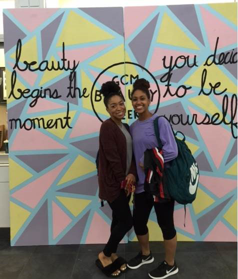  Two seniors at Goose Creek Memorial High School, pose in front of a backdrop during Beauty Week, a Student Council project designed to bring awareness to inner beauty and inner strength. Students organized and implemented the project to spread a positive message throughout the school.  