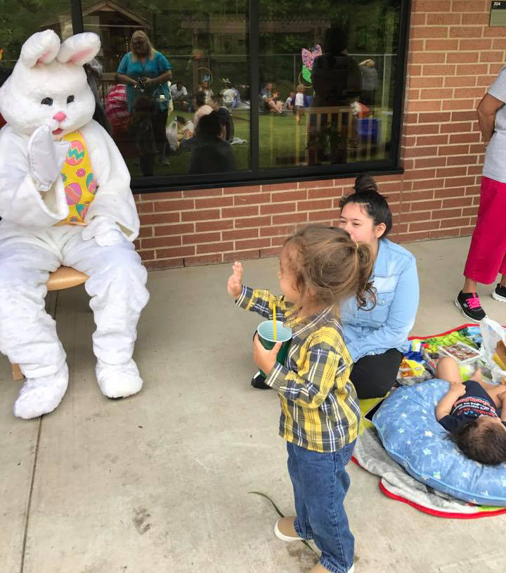 Jordin Lige waves at the Easter Bunny as Alexis Villegas and her son Julian Villalobos enjoy the sunshine at the annual Family Picnic and Easter Egg Hunt at the Peter E. Hyland Center.
