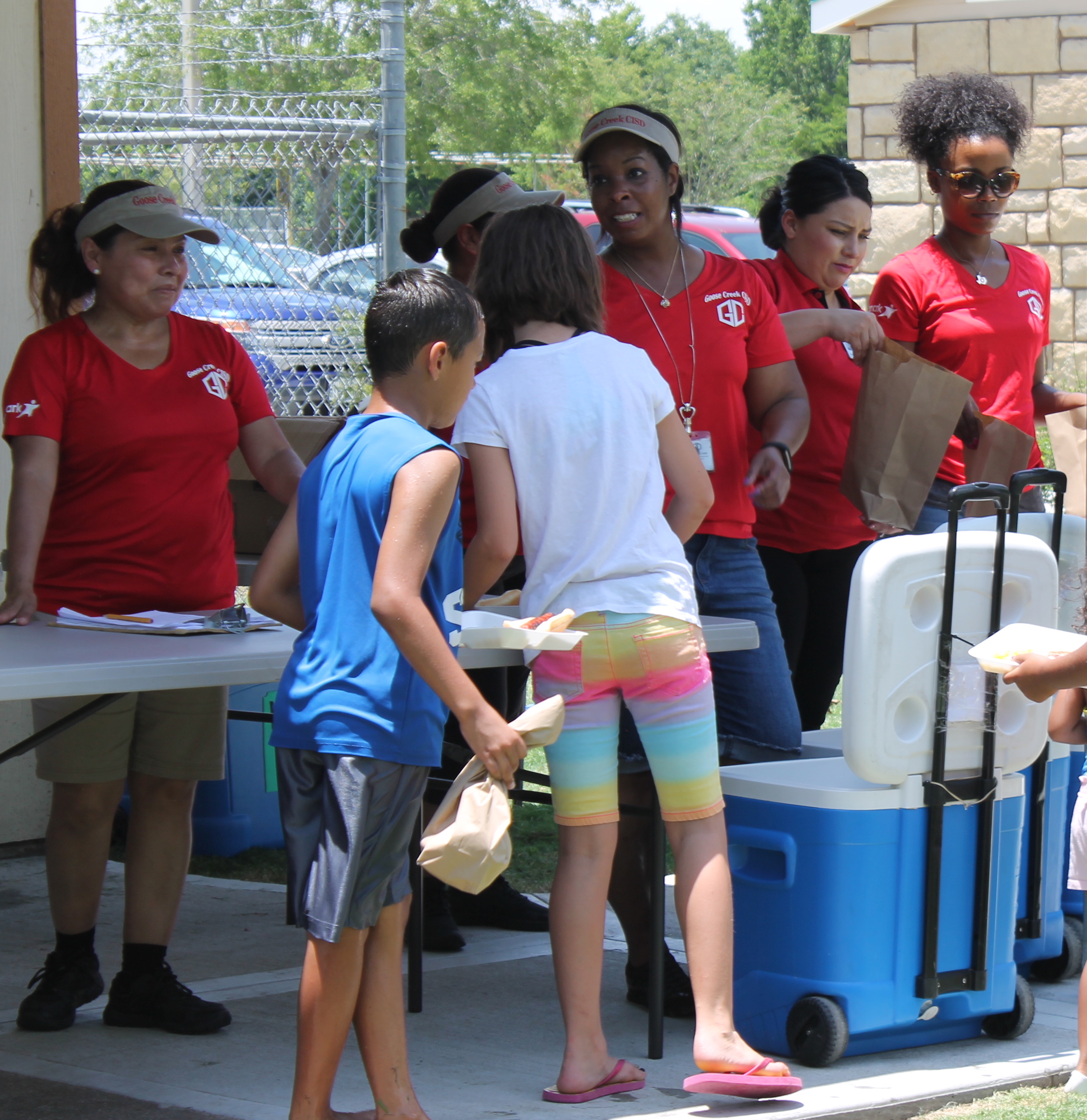  Goose Creek CISD Nutrition Services staff serves hot dog meals to children at the Summer Meals cookout at Jenkins Park June 15. Summer Meals cookouts will be held every Thursday through August 8 at various Baytown and Highlands locations. All children 0-18 eat free. For the complete schedule, go to http://www.gccisd.net/page/FoodServices.SummerMeals. 
