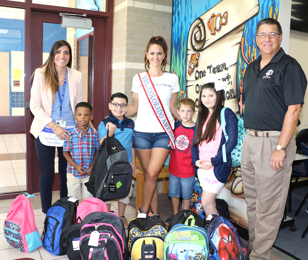  Mrs. Colorado Valerie Daly (middle) with Kiwanian and Goose Creek CISD Board President Al Richard (right), arrive at De Zavala Elementary to deliver backpacks for Goose Creek CISD students affected by Harvey.
Pictured are (from left) Leah Abbate, assistant principal, and students (from left) Tray Smith, kindergarten; Nathan Hinojosa, second grade; Caleb Laramore, first grade and London Esquibel, fourth grade.
Mrs. America USA pageant contestants generously donated to the cause, and several spent time in the district sorting and delivering them.
