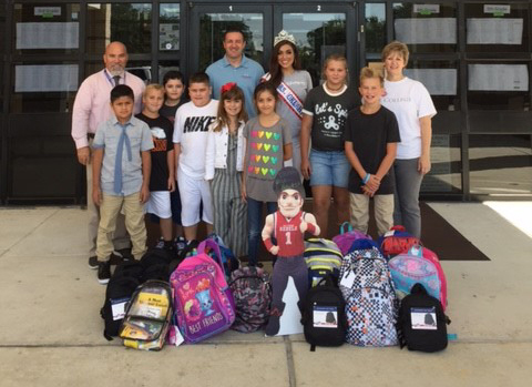  Mrs. Colorado Valerie Daly (middle) with Kiwanian and Goose Creek CISD Board President Mrs. Oklahoma Emerald Stanley (back middle) presents backpacks to Highlands Elementary. Pictured are (front l to r)
Fernando Hernandez, Houston Freeman, Hignacio Martinez, Damian Boutwell, Heidi Martin, Kloe Groff, Olivia Hashaw, Callen Tittel, (back, l to r)
Principal Edward Villanueva, Kiwanian Chad Merling and Lee College Community Engagement Specialist Donna Mohlman.  