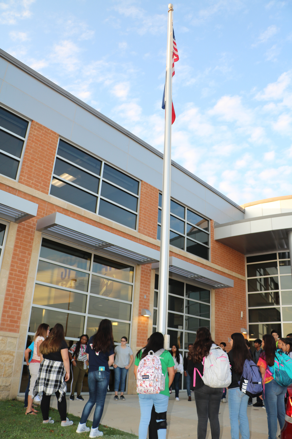   Students at IMPACT Early College High School observe See You at Pole by rallying around the flagpole to pray Wednesday morning.
