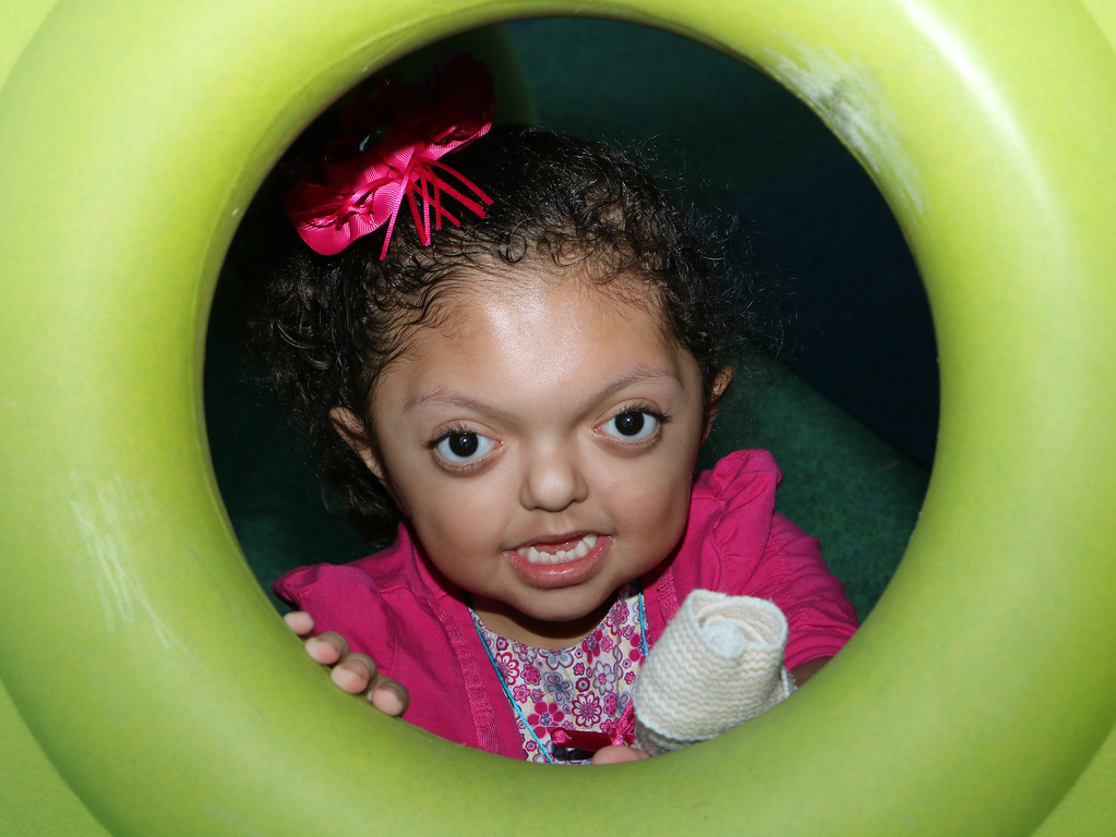  Ashley Paz Turcios looks through an opening in some adaptive playground equipment during the William B. Travis Park Inclusive Playground ribbon cutting ceremony. The playground was a project of the City of Baytown, Goose Creek CISD, Rotary Club of Baytown and Kiwanis Club of Baytown to provide equipment for all children.