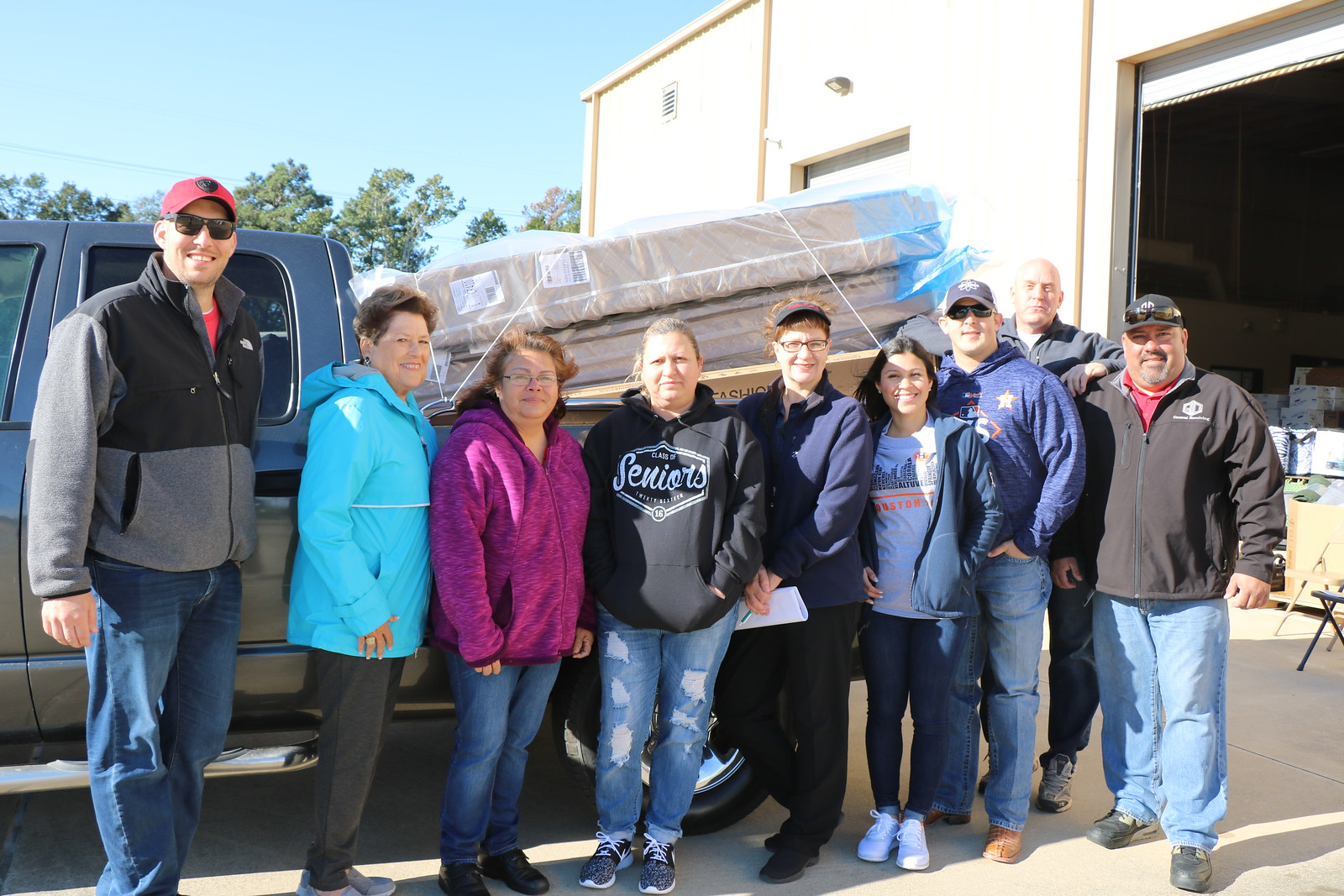  Gracie Cano (third from left) and Genoveva Cardenas (fourth from left), employees at Ross S. Sterling High School, prepare to take the mattresses, donated by Chevron Phillips Chemical Co. through the Goose Creek CISD Education Foundation, home for their children.  Also pictured are (from left) Jon Howerton from Mattress Firm; Sandra Bell, Education Foundation member; Ginger McKay, director of federal programs for GCCISD; Erika Foster, Education Foundation director; Ryan Foster from Envasco; Mike Salgy, Chevron Phillips training coordinator, and Rafael Cantu, GCCISD Warehouse supervisor. 