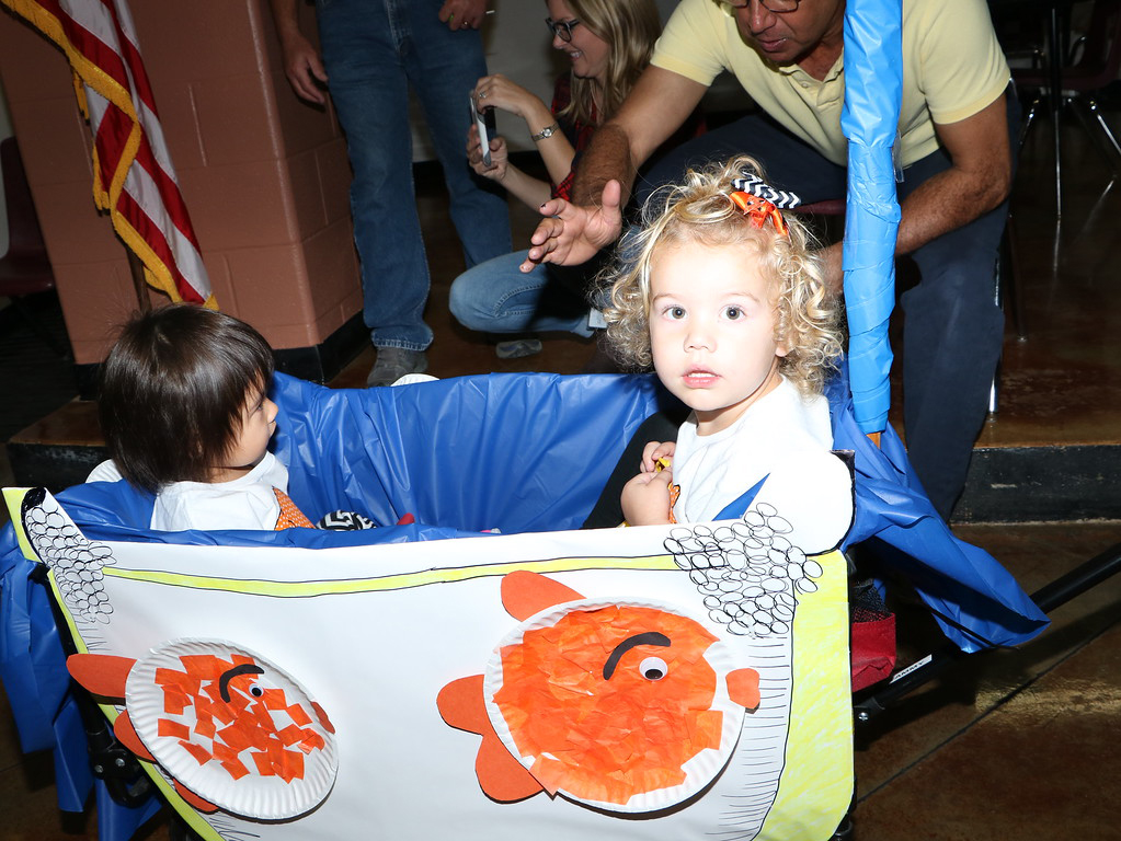  (from left) Emma Reyes and Josephine Johnson ride in the fish bowl in the Dr. Seuss-themed Halloween Parade at the Peter E. Hyland Child Care Center. 