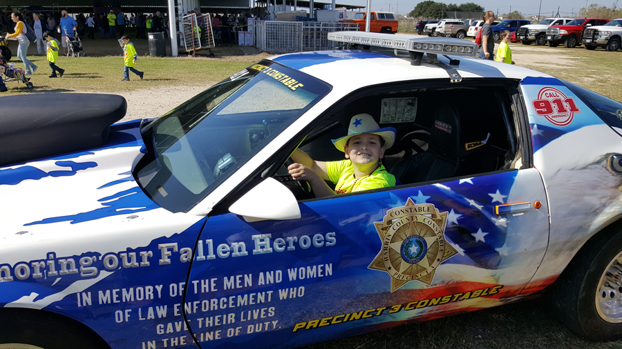 
Andrew Rye, second-grader at Stephen F. Austin Elementary, enjoys sitting in the Precinct 3 Constable’s vehicle at the Baytown Special Rodeo held recently at the Baytown Youth Fairgrounds.
