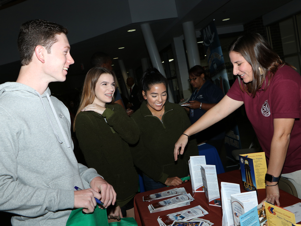(from left)  Clayton Maddie, Skylar Liles and Nicole Barragan, students from Ross S. Sterling High School get information from Rebecca Montz with Galveston College at Goose Creek CISD’s recent College Night held at Goose Creek Memorial High School. 