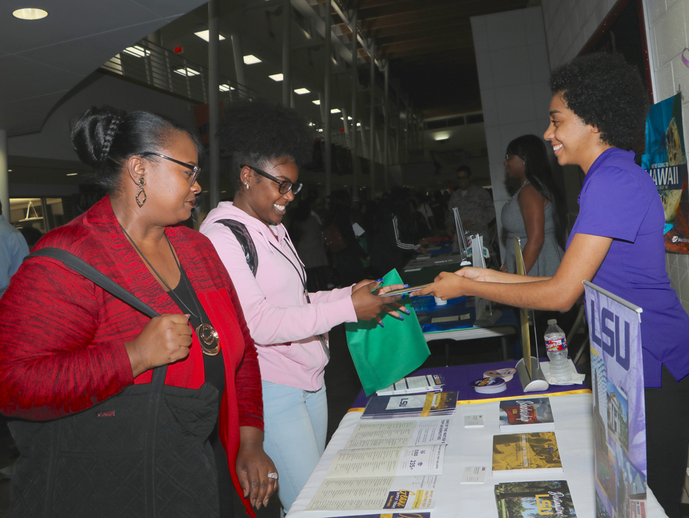Demoria Howard (second from left), a student at Goose Creek Memorial High School, and her grandmother Emma Miller talk to Chrystal Cantrell with LSU at Goose Creek CISD’s recent College Night.
