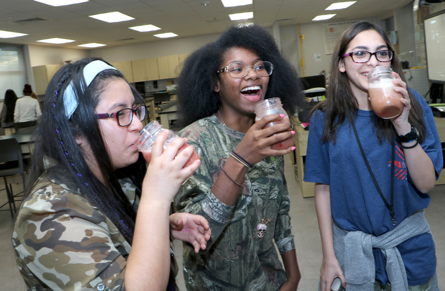  Thaily Zamarripa, Tiarra Stewart and Josilyn Mondragon, members of the IMPACT ECHS Spanish Club, prepare to drink the healthy shakes they concocted. 