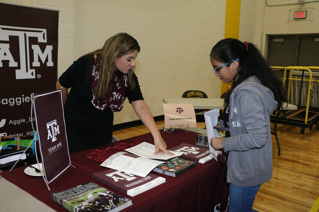  Yaretmy Trejo (right), eighth-grader at Highlands Junior School, discusses college opportunities with Grace Collins from Texas A & M  University at the recent HJS 2nd Annual College and Career Fair.