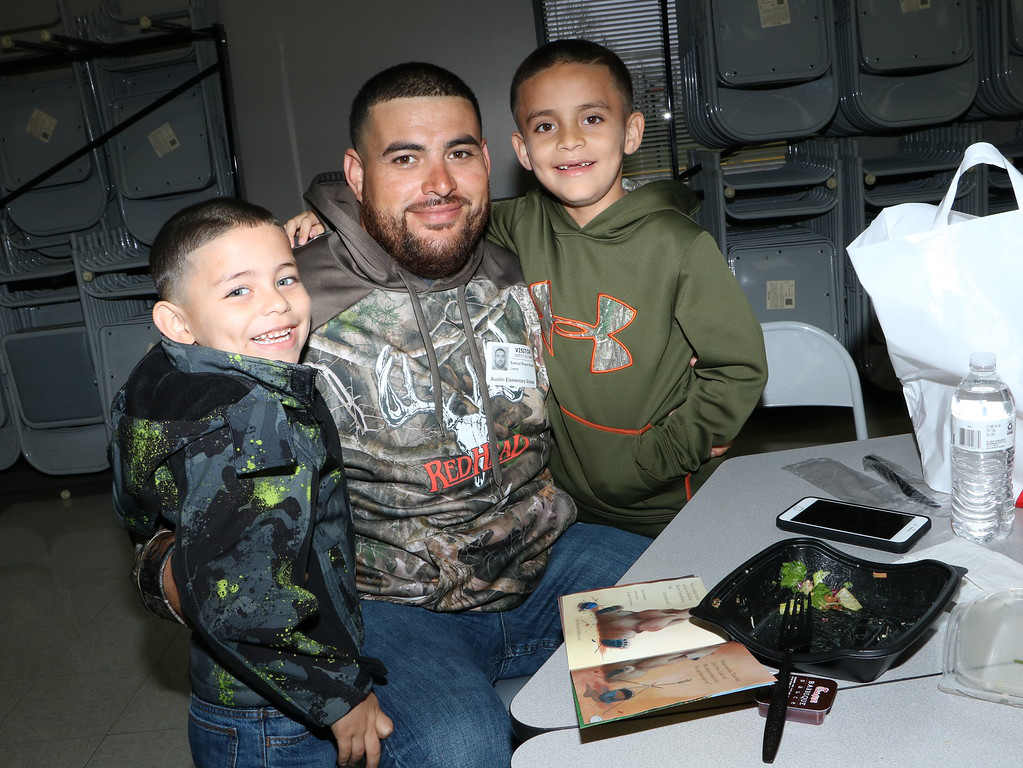 
Samuel Reyes (middle) has lunch with his sons Angel (left), a pre-kindergarten student, and Samuel, a second-grader, at Stephen F. Austin Elementary on a cold, rainy day.
