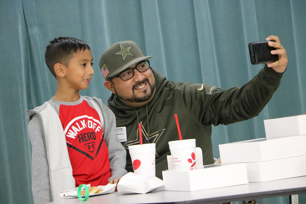 
Kevin Martinez (right) takes a selfie with his son Matthew after bringing lunch and cookies for his class at Stephen F. Austin Elementary on his eighth birthday, oblivious to a crew from ESPN recording them. ESPN is producing “We the Fans/Dallas Cowboys,” a documentary about the interesting lives of Dallas Cowboys season ticket holders, and Martinez was selected. The lunch date was just one of the events in Martinez’ life that ESPN has recorded over the past three months. The documentary will air in April 2018.
