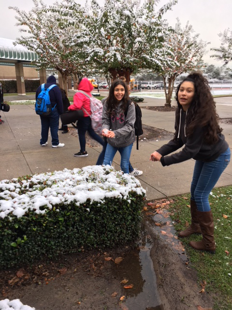 
(from left) Shakira Medina and Estefhany Espino from Horace Mann Junior School, enjoy the snow before school Friday.
