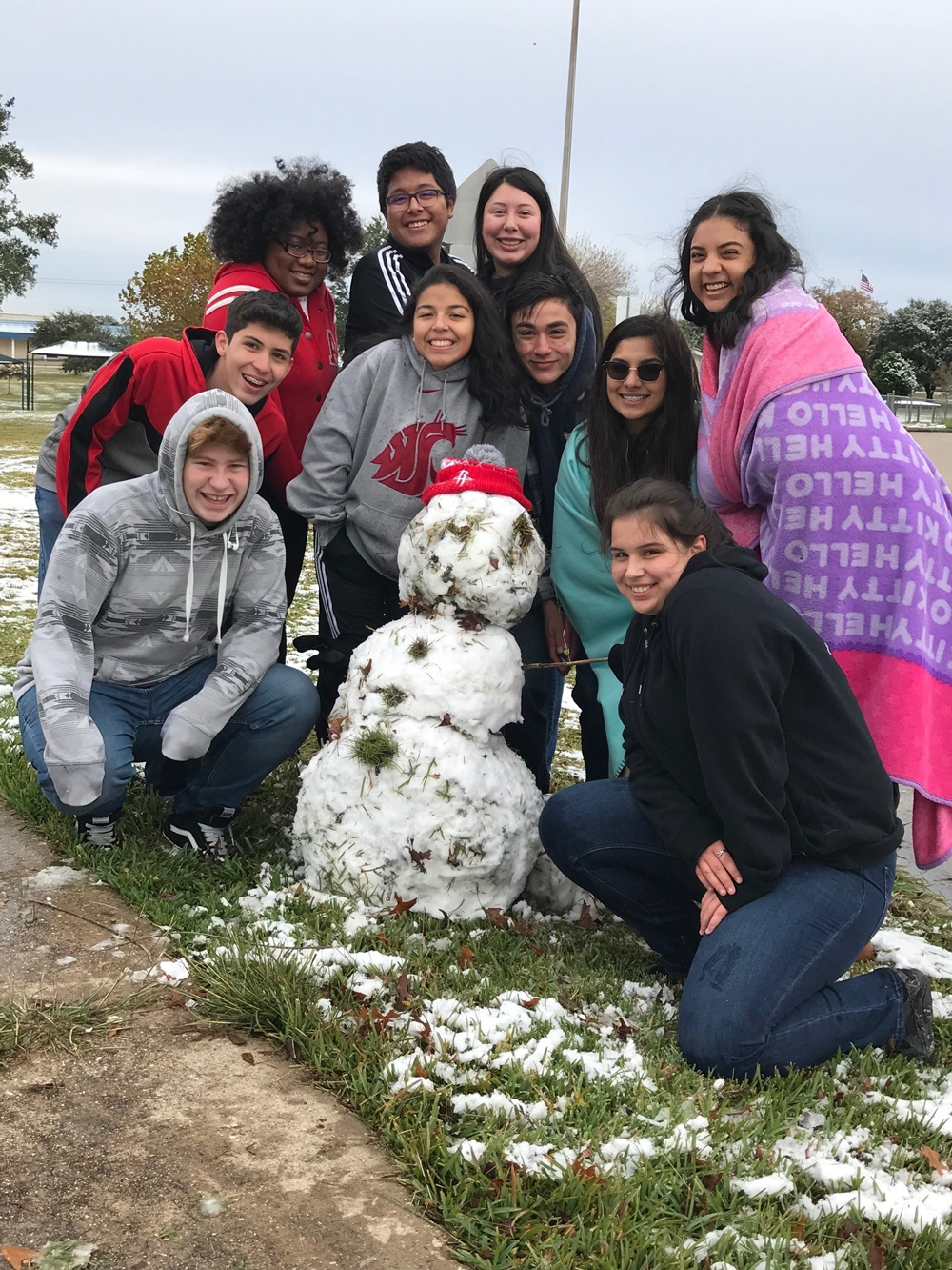  IMPACT Early College High School students Chase Brandon, Everett Crutchfield, Lauryn Tolliver, Miguel Amaro, Brittney Amezcua, Maria Gelves, Andrew Cantu, Citlalli Caltzontzin, Nathalia Gonzalez, and Luz Garcia show off the snowman they built before school Friday.