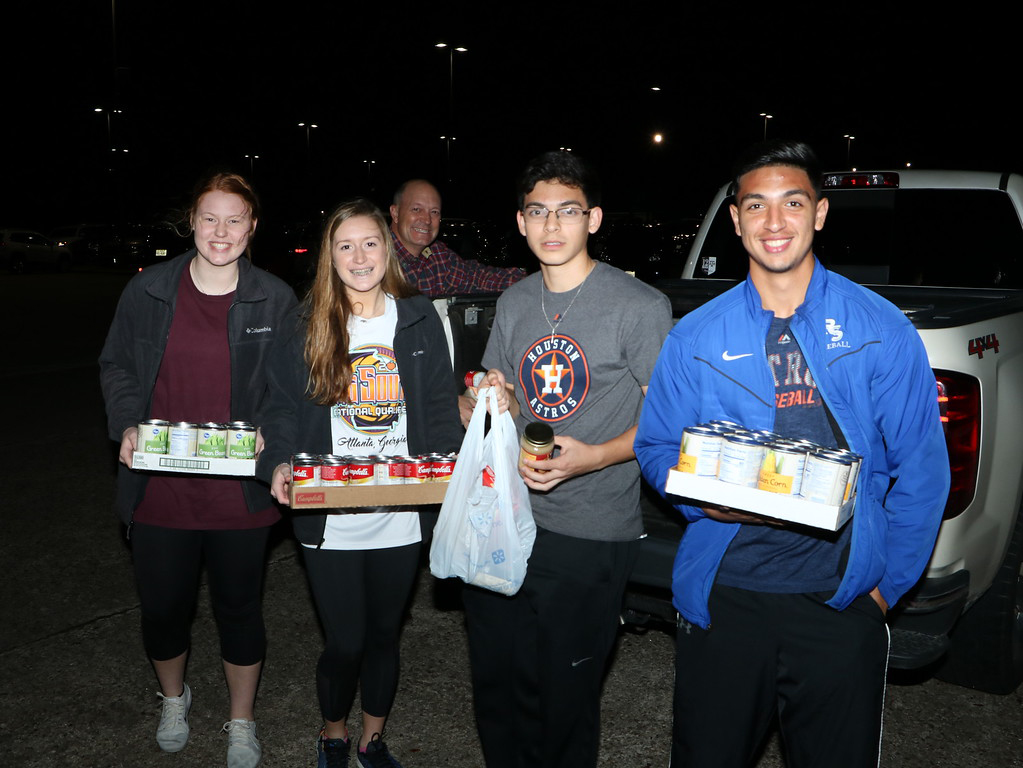  Megan Clausen, Casey Benskin, parent/driver Phillip Benskin, Sergio Cantu and Cesar Prieto unload the canned goods they collected during the annual HO HO HO Scavenger Hunt. This year, 34 teams, including 273 Ross S. Sterling High School students and 42 teachers/administrators/parents participated, collecting 10, 220 food items to be given to Channel 13’s Share Your Christmas Food Drive in the Walmart (Garth Road) parking lot.