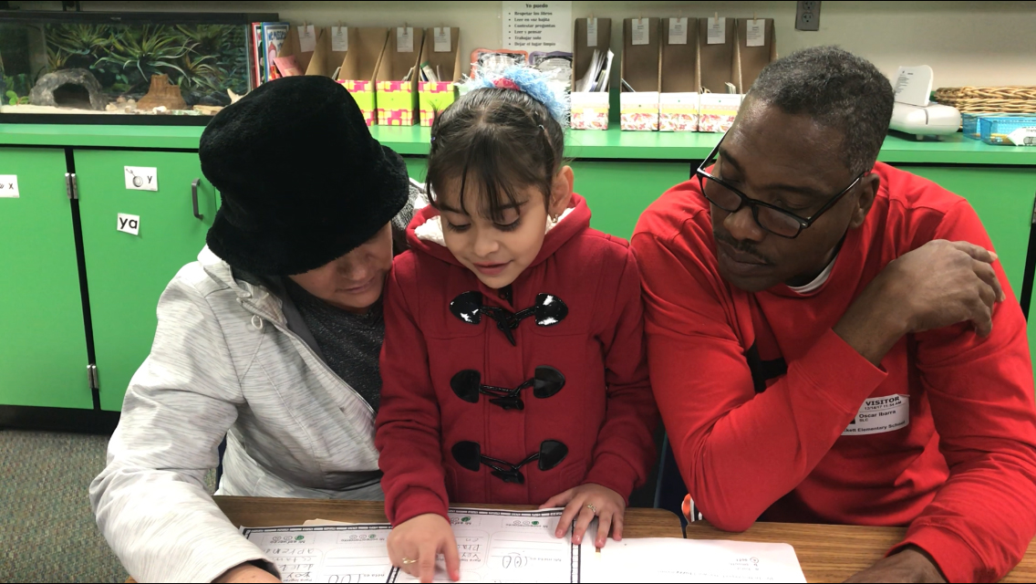 
Lilianna Vera-Chavez  and her parents Guadalupe Chavez and Oscar Ivara look at her work during Student Led Conferences at Crockett Elementary. Parents, district administrators and community members attended conferences to look at students’ work and to help them establish academic and social goals.
