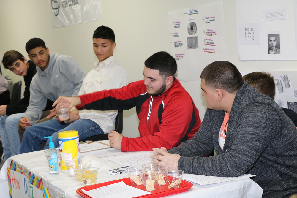 
Stuart Career Tech High School students (from left) Edgar Silva, Raleigh Baggett, and McKale Schiappa prepare to share the poems they wrote in Debbie King’s English class, while Jason Hernandez, Joshua Eastman and Rick Reyes demonstrate osmosis in eggs, an experiment from Stephanie Brock’s biology class, during the recent SCTHS Student Showcase.
