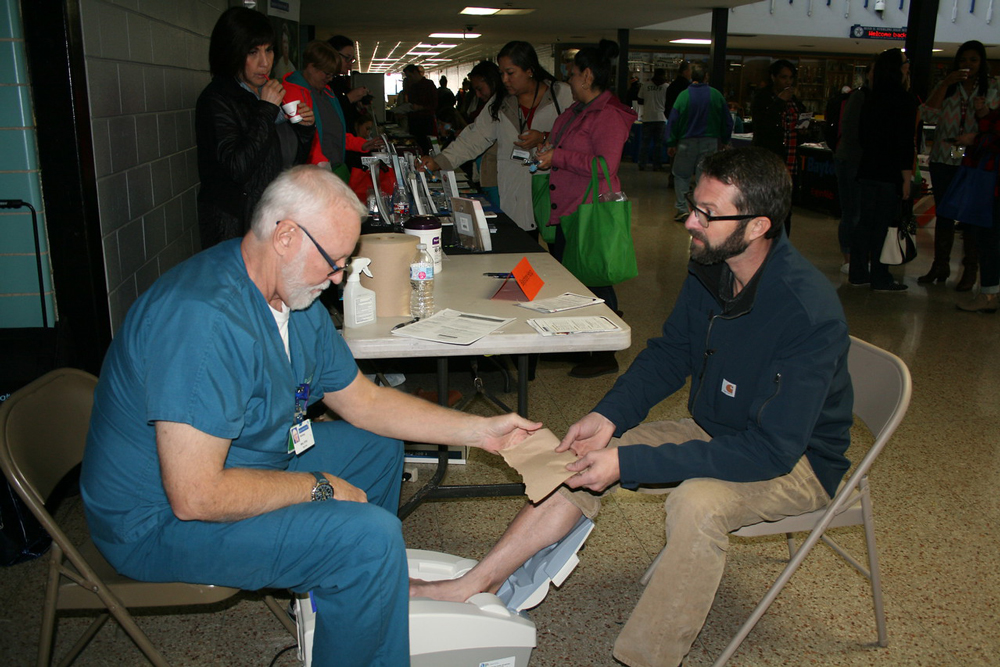  David Laughlin (right) from Horace Mann Junior School participates in a bone density screening with Mike Waddell from Bayshore Hospital at the first Wellness Fair for Goose Creek CISD employees.
