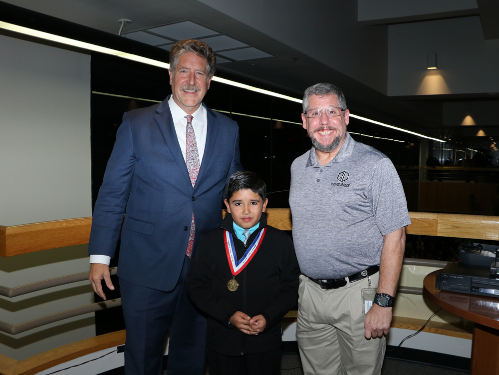 
Alfredo Vega (middle), third-grader at Carver Elementary, is congratulated by Randal O’Brien, Goose Creek CISD superintendent, for receiving the Elementary School Gold Medal in the Houston Livestock Show and Rodeo School Art Contest. With him is his art teacher Harry Barber.
