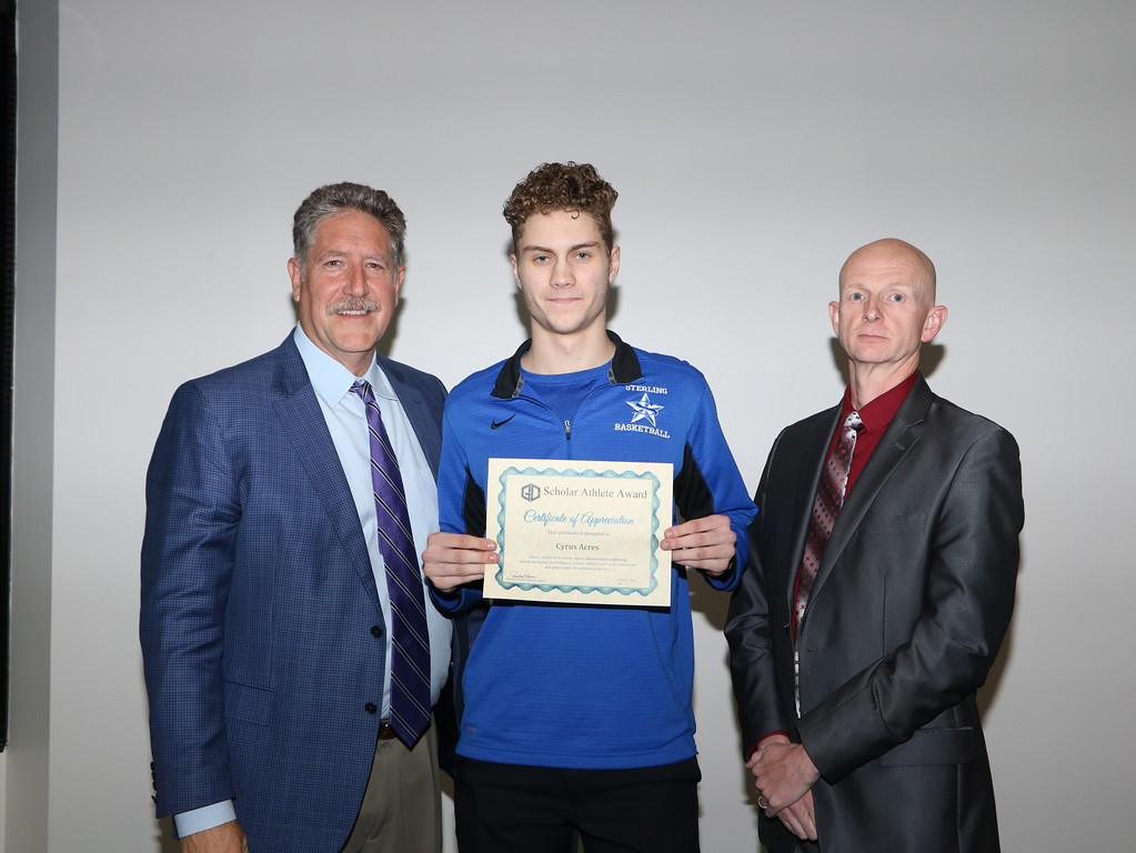 
Acres (middle) a senior at Ross S. Sterling High School, is congratulated at a recent board meeting by Randal O’Brien (left), Goose Creek CISD superintendent, and Pete Pape, board president, as a January Scholar Athlete. Cyrus plays basketball and is in the top 10 percent out of 609 in his class. He is also involved in orchestra and water polo. Cyrus is under the direction of Coach Greg Smith and Principal Nathan Chaddick.
