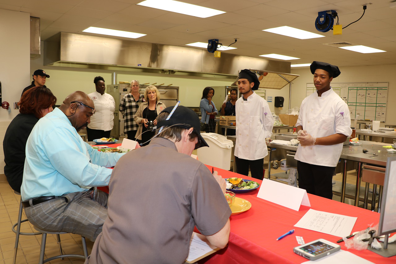  Judges (from left) Chef Cheyenne Peer from the Cooking Connection at H-E-B; Dr. Anthony Price, assistant superintendent for administrative services and Chef Tina Andrade from Stuart Career Tech High School
question Brayan Franco and Haylon Haynes  while tasting the baked chicken nachos they prepared during the local Latin Fusion – Lone Star Chef Competition as Aramark employees wait to hear the final results.