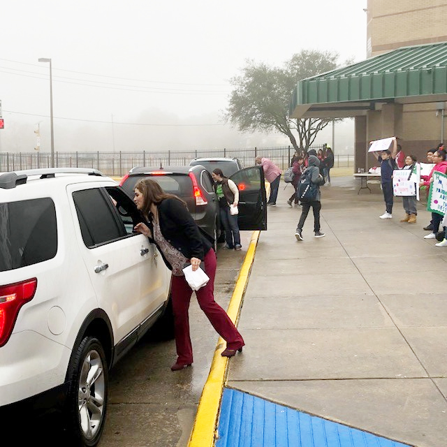 
Horace Mann Junior School administrators and counselors hand out bags of doughnut holes to parents on Valentine’s Day to show them their appreciation. Pictured are (front to back) Erica Tran, HMJ principal; Areasha Hebert, student support administrator and Earnest Brooks, assistant principal, giving out the treats, and HMJ students holding signs thanking the parents as they drop off their students. PTO members also assisted.
