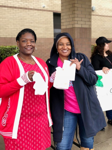 
From left, Alexis Trotty and Jackie Booker, counselors at Horace Mann Junior School, prepare to hand out doughnut holes to parents on Valentine’s Day to parents to show their appreciation. Students and PTO members assisted and displayed signs thanking the parents.
