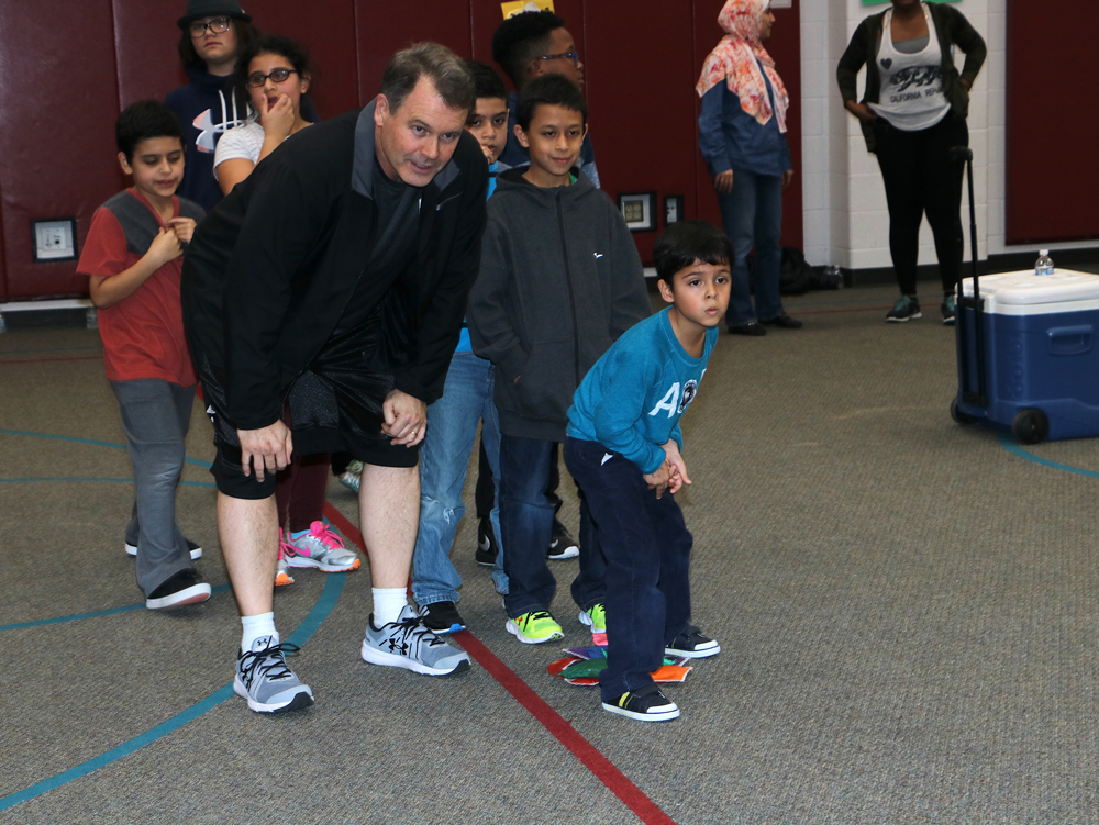 
Coach Tim Bailey (left) and Rodrigo Solano, second grade, get ready to race the parents during Alamo Elementary School’s Fitness Frenzy, hosted by the Baytown YMCA and Aramark. Participating in fitness activities, eating healthy snacks and reading in the library helped families exercise their bodies as well as their brains.
