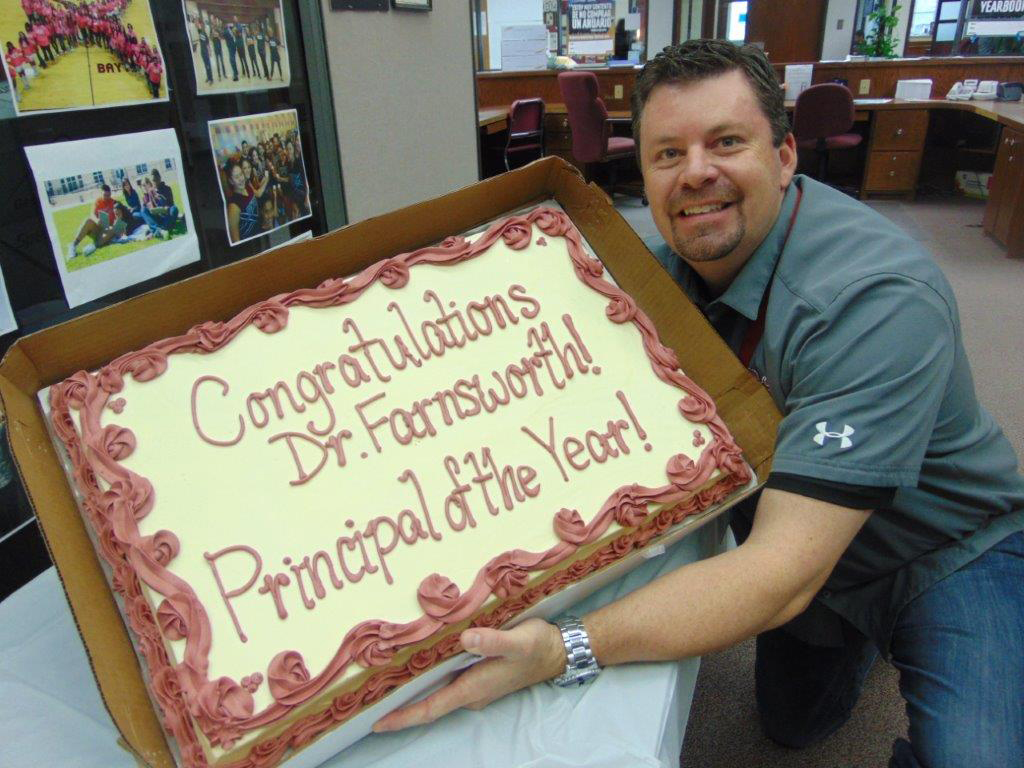 
Dr. Joseph Farnsworth, principal of Robert E. Lee High School, shows off the cake his staff presented to him in honor of being named Secondary Principal of the Year.
