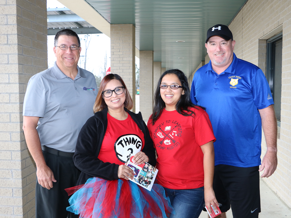 
Austin Elementary bus monitors (from left) Vanessa Rangel and Regina Aguilar are presented with gift cards by Kevin Jones (right), campus athletic director at Cedar Bayou Junior School and parent of an Austin student, joined by Al Richard, Goose Creek CISD board member. Jones says they are always outside, rain or shine, smiling brightly and helping students off the buses and into the building. Not pictured is Kelsey Laughlin, who also received a gift card. 