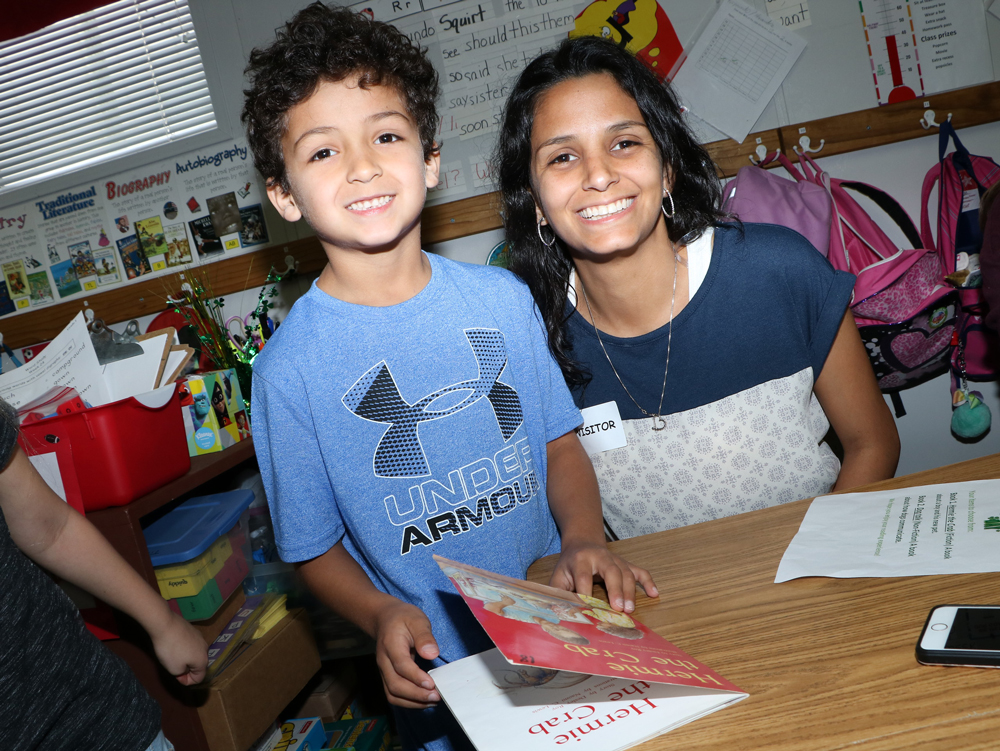 Crockett Elementary first-grader Kyler Tilley reads to his mother Carmen Arellano after she chooses a book from his menu at Crockett’s Reading Restaurant.
