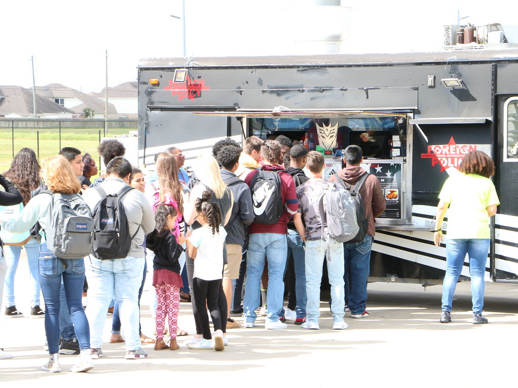 
Goose Creek Memorial High School students stand in line to purchase lunch from food trucks. 