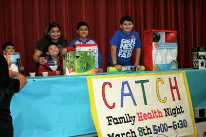 Daniel Sanchez, first grade; Laura Montoya mother of Jacob Campos third grade, and Johnathan Campos fourth grade; and Eduardo Delgado, fifth grade, win prizes at Lamar CATCH Night. 