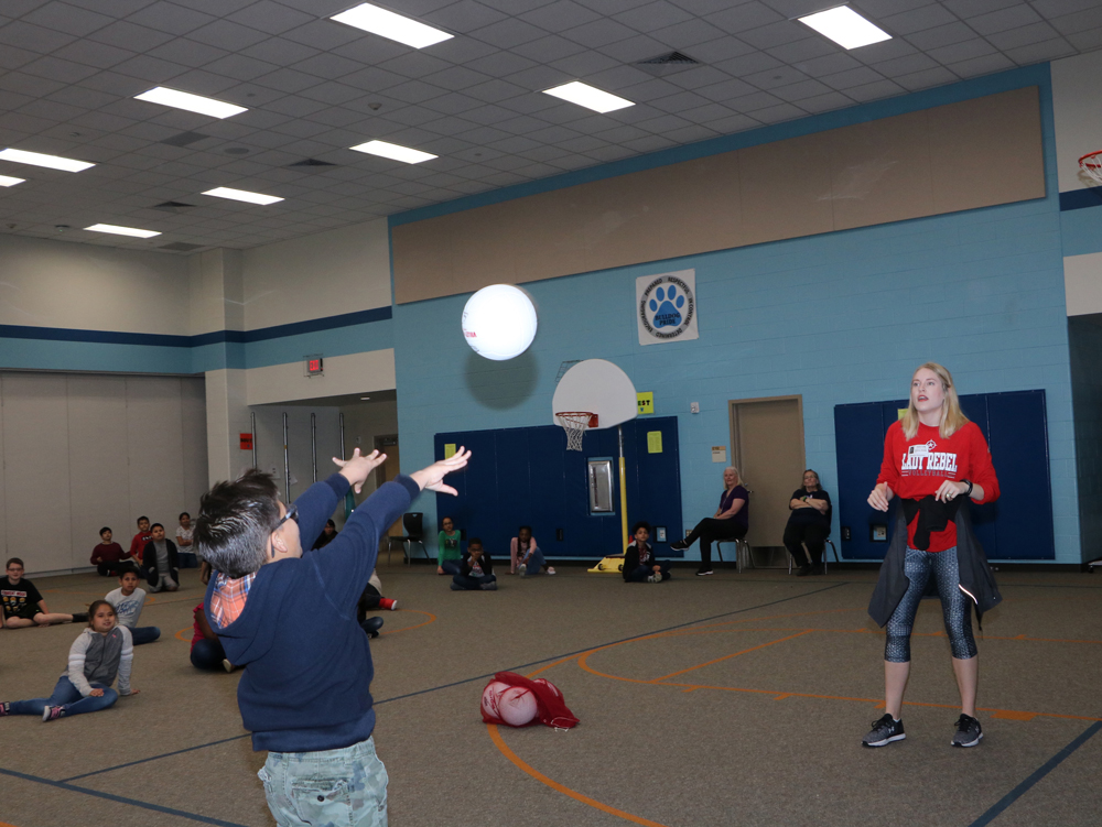 
Steven Gonzalez sets back at Whitney Moffitt, Lee College assistant volleyball coach, when she came to Bañuelos Elementary recently to discuss volleyball skills with students.
