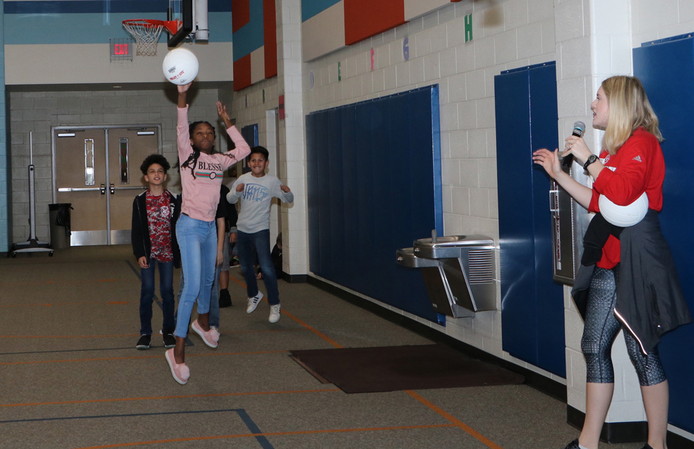 
Bañuelos student Meime Mitchell spikes the volleyball, while Joseph Beharry (left) and Arath Nunez (right) watch.
Whiney Moffit (far right), Lee College assistant volleyball coach, gives instructions.

