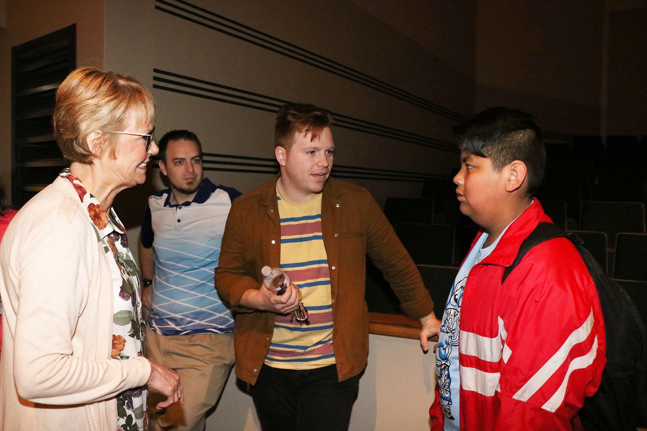  Leeland Mooring (second from right) from the band Leeland, discusses music with Javier Talavera, a seventh-grade CSU student at Horace Mann Junior, before performing some of his songs for the CSU group.
