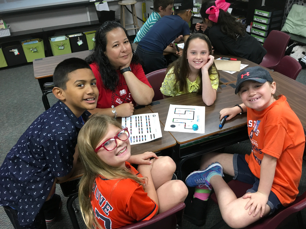 
Austin Elementary students and librarian Karen Trujillo (third from left) work with an Ozobot coding the plot structure of a story before writing the summary. Pictured are (from left) Brielyn Henry, Anthony Snchez, Trujillo, Reese Malpass and London Merlin.