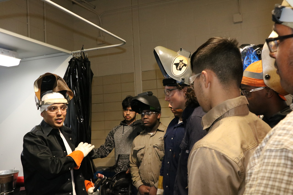 
Hjalmar Aguilo (left), a welding instructor who demonstrates welding techniques on YouTube (WeldTube), gives some advice to welding students at Stuart Career Center. Students pictured are (from left) Sergio Guerra, Shemar Deblanc, Kyler Hardison, Tyrus Jackson, Daniel Alvarez and Ulises Benavides.

