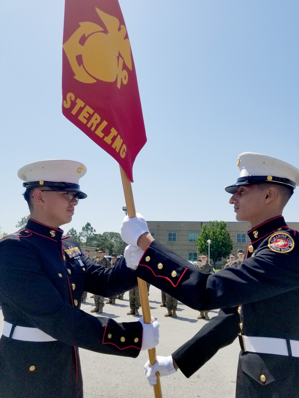  Cadet LtCol Isaiah Cano (left) presents the flag to Cadet LtCol Giovanni Cruz during the Change of Command presentation during the recent Ross S. Sterling High School MCJROTC Awards Ceremony. The RSS MCJROTC is under the direction of Col P.J Ferral USMC (Ret), Senior Marine Instructor, and Master Sergeant Martin Jeffrey, Marine Instructor.