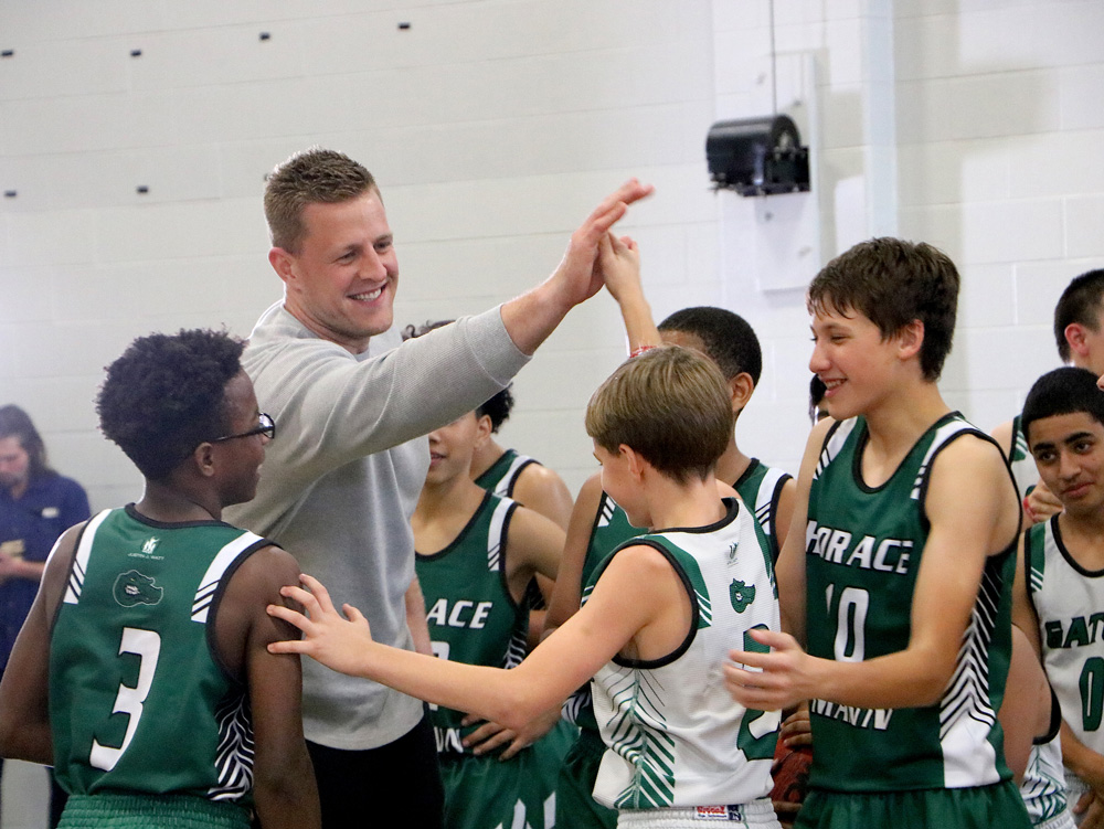 
J. J. Watt high-fives a Horace Mann Junior School basketball player after shooting some hoops with the team. The Justin J. Watt Foundation donated some athletic equipment to HMJ, and the students were excited to have the opportunity to thank J. J. in person.
