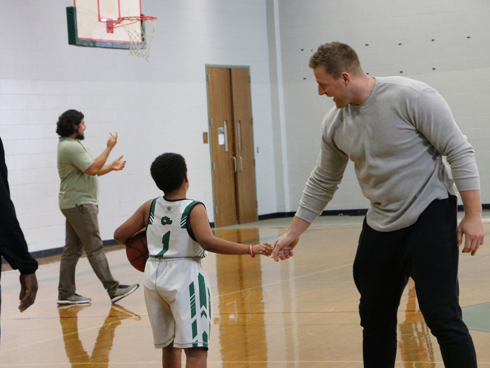  J. J. Watt shakes hands with Nathan Thompson at Horace Mann Junior School. Watt interacted with students and played a little basketball. Watt’s Foundation donated athletic equipment to the school two years age.
