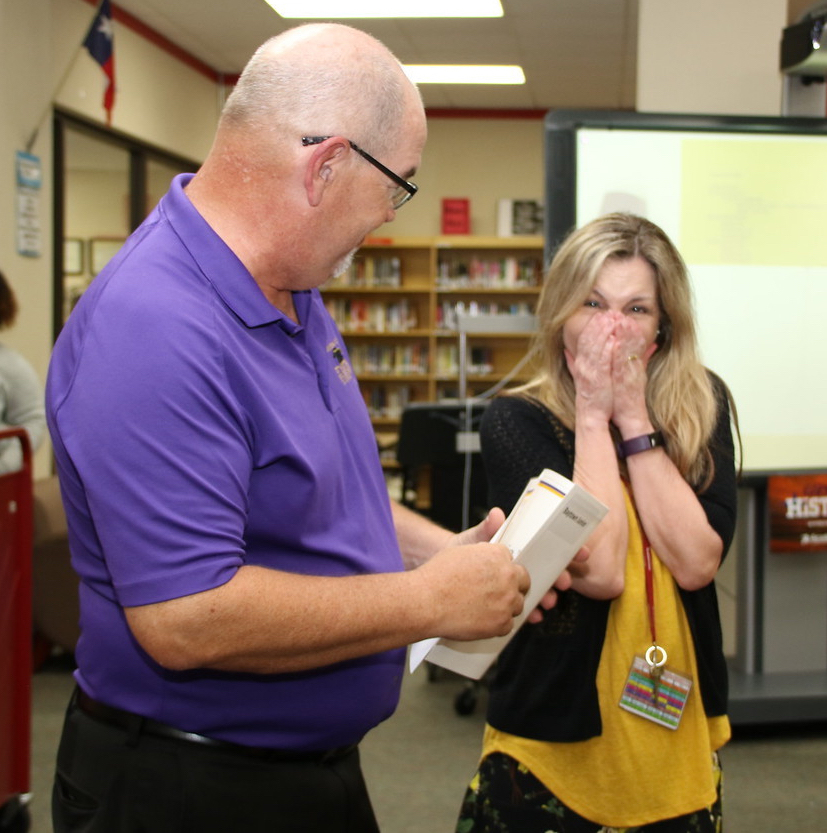 
Jim Wadzinski (left), vice president of development of the Goose Creek CISD Education Foundation, helps the Grant Surprise Patrol present Janie West, librarian at Baytown Junior School, with a check for $1,827.99 for “Changing Dreams into Reality; Virtually.”
The Foundation recently awarded more than $141,700 in innovative teaching grants to Goose Creek CISD teachers.
