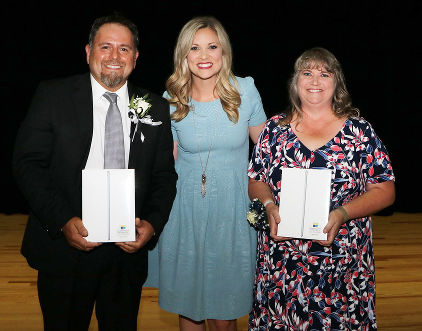 
Macie Schubert from Community Resource Credit Union presents iPads to District Teachers of the Year Troy Flores (left) from the Peter E. Hyland Center and Bekki Bishop from Harlem Elementary.
