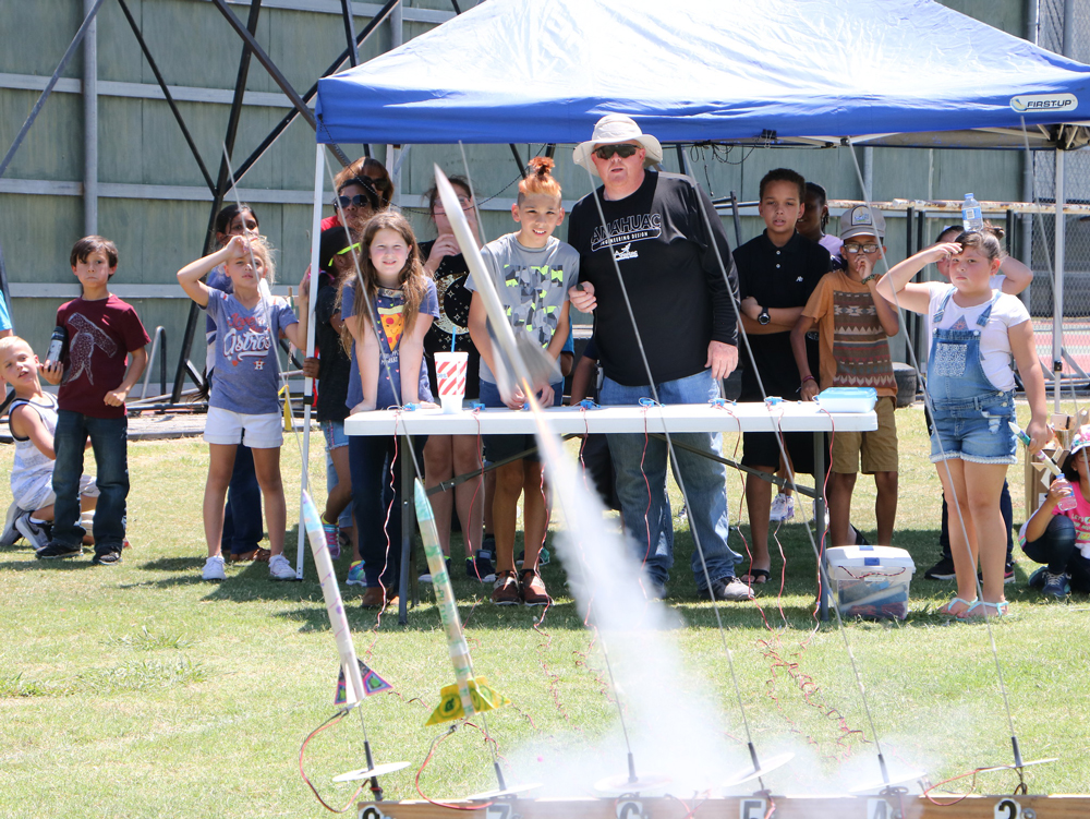 
Kirk Moore (front), facilitator of Goose Creek CISD’s Rocketry Camp, and campers watch as a student-made rocket is launched on the last day of camp.

