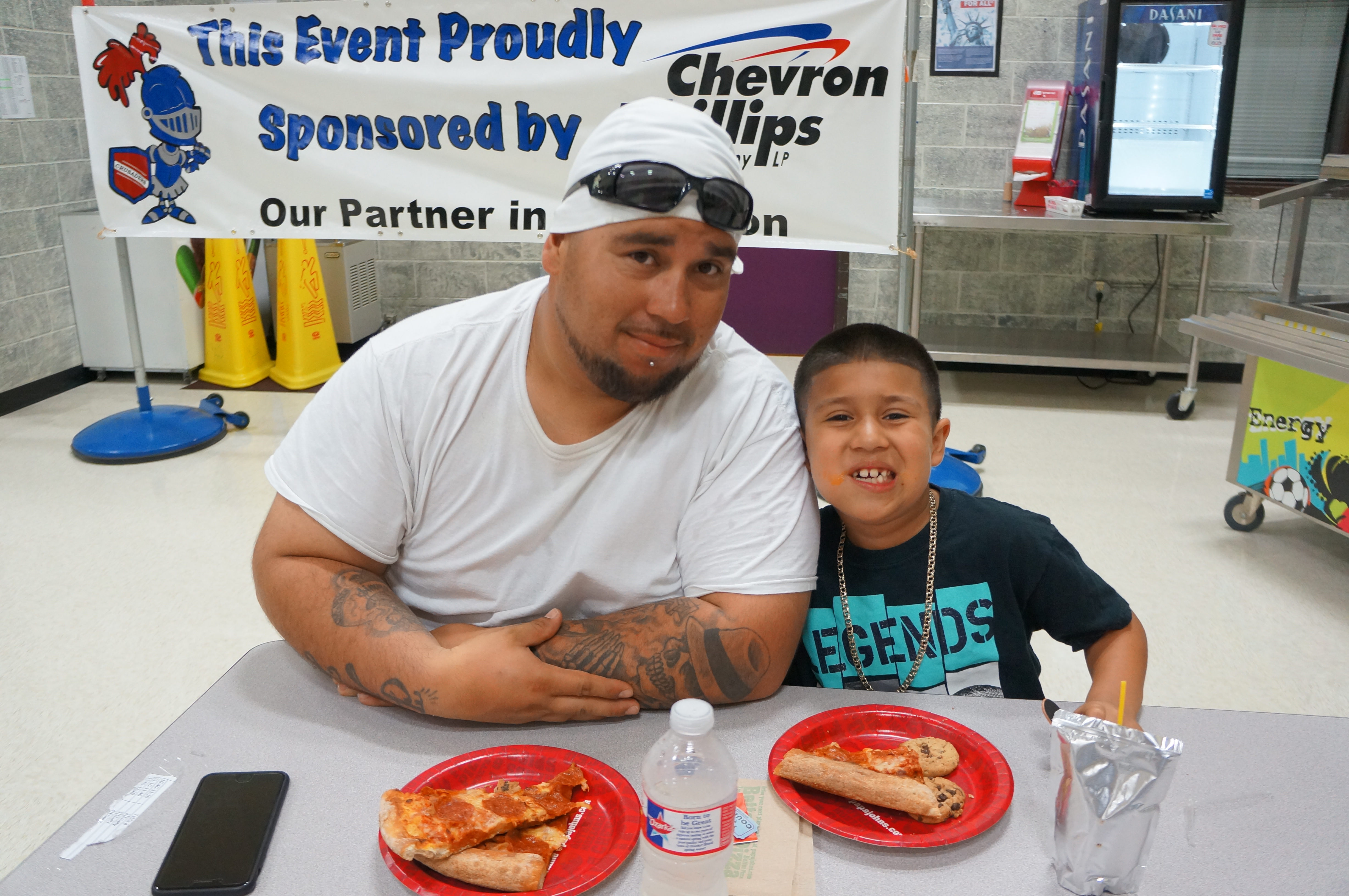  Angel Lopez (right) enjoys the Watch D.O.G.S. Program Pizza Launch Event at Crockett Elementary with his father Jimmy Lopez. The program encourages fathers/father figures to volunteer and serve as positive male role models at school.