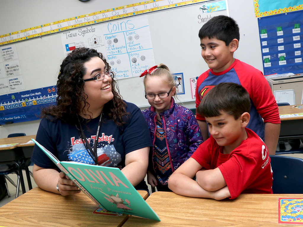  A first-year teacher at Hopper Primary and a product of the Ready, Set, Teach! Program at Sterling, reads a book to her first-graders. 