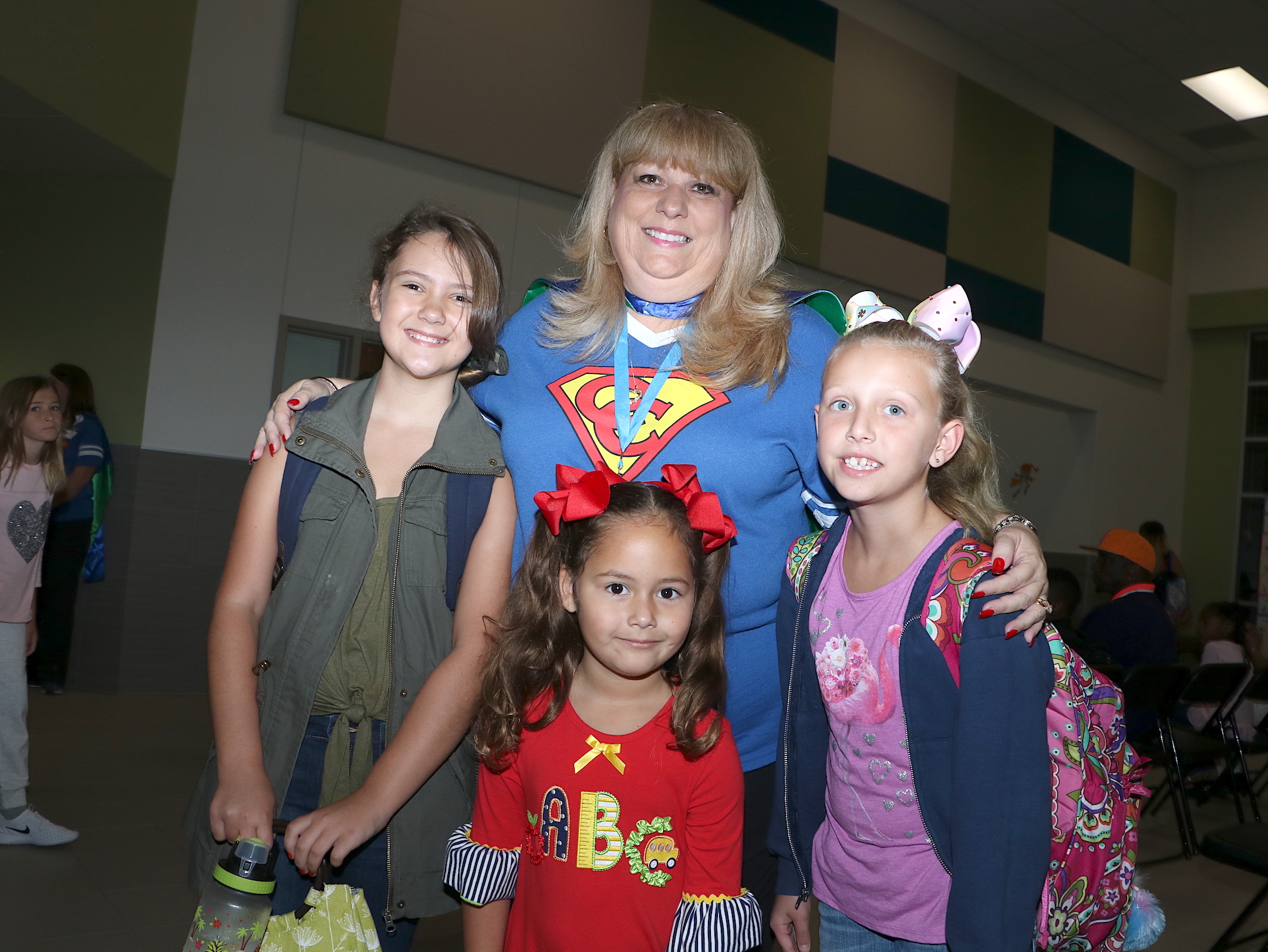  (Front, from left) Gracie Gaskey, fifth grade; Ally Arebalo, kindergarten, and Avery Senn, fifth grade, are greeted by their new principal Katherine Cruz at Dr. Johnny T. Clark, Jr. Elementary. 