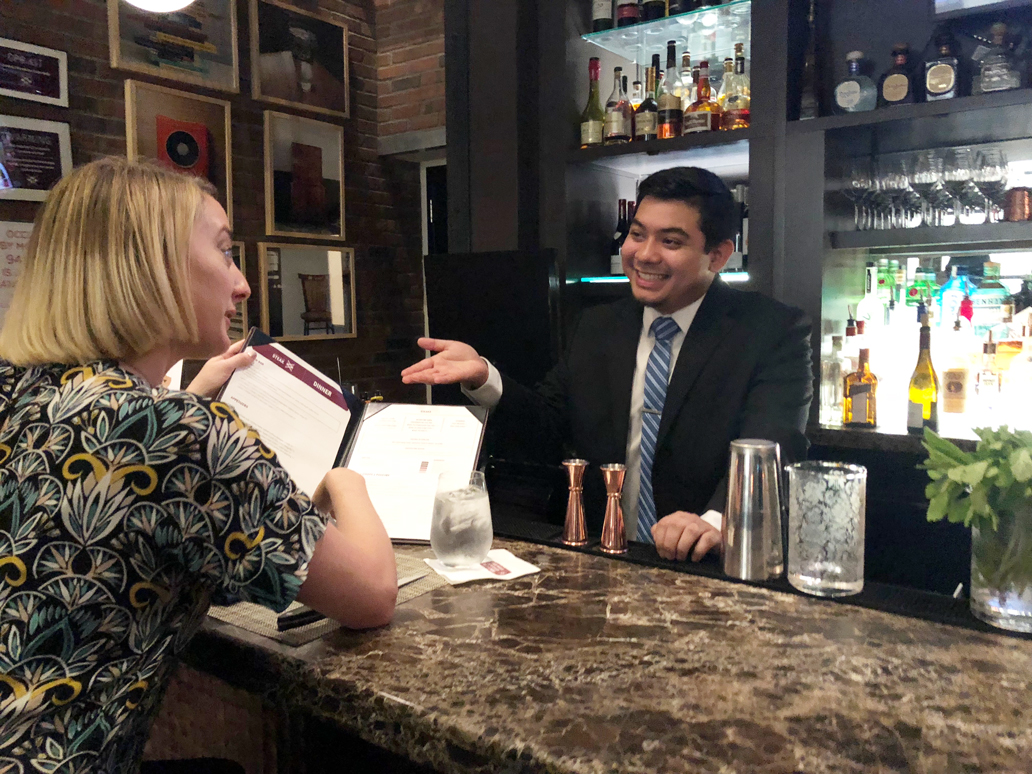 Adrian Pantoja greets a customer at restaurant