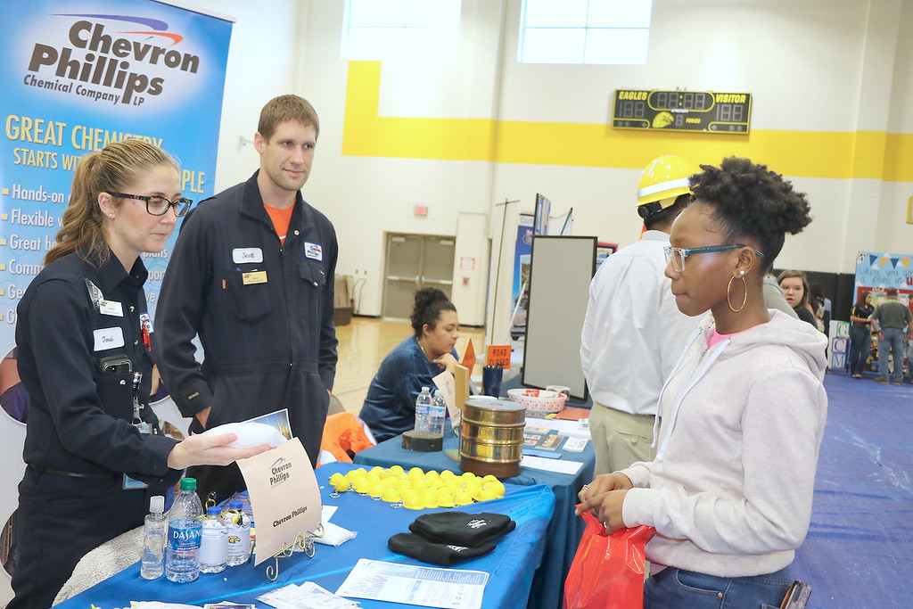Student speaks to Chevron Phillips employees about career.